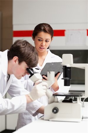 simsearch:400-05669968,k - Portrait of a science student looking in a microscope in a laboratory Stock Photo - Budget Royalty-Free & Subscription, Code: 400-05669972