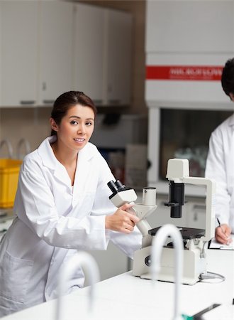 simsearch:400-05669968,k - Portrait of a good looking science student using a microscope in a laboratory Stock Photo - Budget Royalty-Free & Subscription, Code: 400-05669984