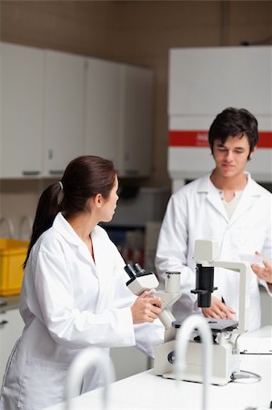 Portrait of a good looking science students using a microscope in a laboratory Stock Photo - Budget Royalty-Free & Subscription, Code: 400-05669987