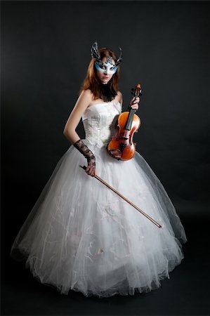 Girl in white dress and mask with violin on black background Stock Photo - Budget Royalty-Free & Subscription, Code: 400-05663320
