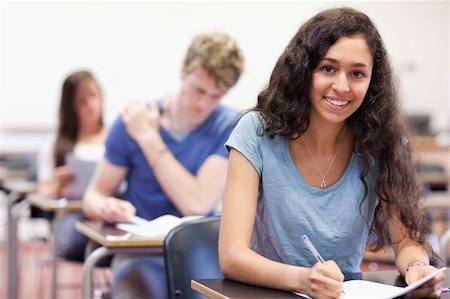 simsearch:400-05677768,k - Smiling students working on an assignment in a classroom Stock Photo - Budget Royalty-Free & Subscription, Code: 400-05677759