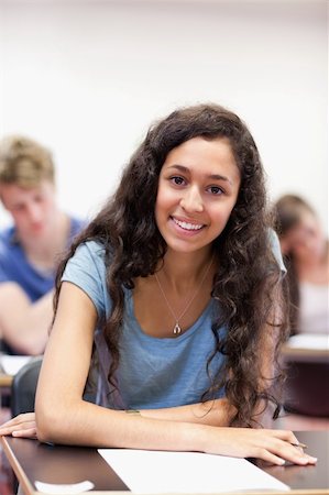 simsearch:400-05677768,k - Portrait of a happy student working on an assignment in a classroom Stock Photo - Budget Royalty-Free & Subscription, Code: 400-05677764