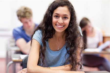 simsearch:400-05677768,k - Happy student working on an assignment in a classroom Stock Photo - Budget Royalty-Free & Subscription, Code: 400-05677765