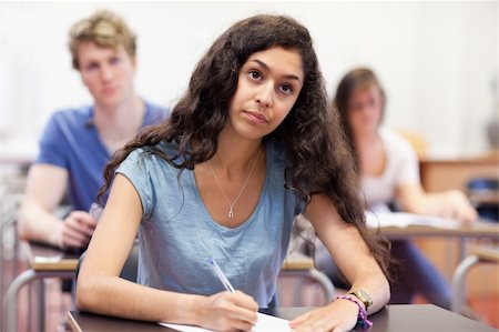 simsearch:400-05677768,k - Focused student taking notes in a classroom Stock Photo - Budget Royalty-Free & Subscription, Code: 400-05677768