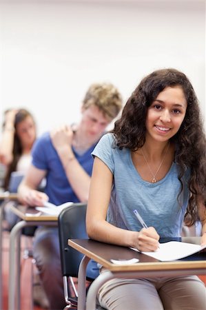simsearch:400-05677768,k - Portrait of smiling students working on an assignment in a classroom Stock Photo - Budget Royalty-Free & Subscription, Code: 400-05677760