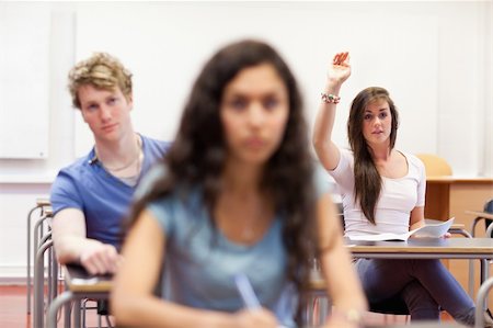 simsearch:400-05677768,k - Student raising her hand to give an answer in a classroom Stock Photo - Budget Royalty-Free & Subscription, Code: 400-05677774