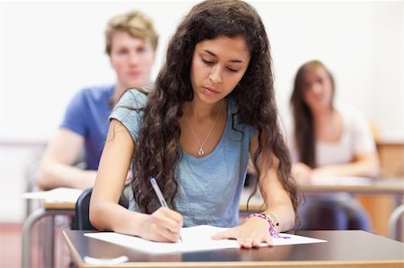 simsearch:400-05677768,k - Students taking notes while their classmates are listening in a classroom Stock Photo - Budget Royalty-Free & Subscription, Code: 400-05677775