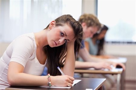 simsearch:400-05677768,k - Serious woman writing in a classroom Stock Photo - Budget Royalty-Free & Subscription, Code: 400-05677787