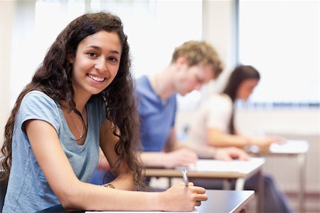 simsearch:400-05677768,k - Happy young adults writing in a classroom Stock Photo - Budget Royalty-Free & Subscription, Code: 400-05677794