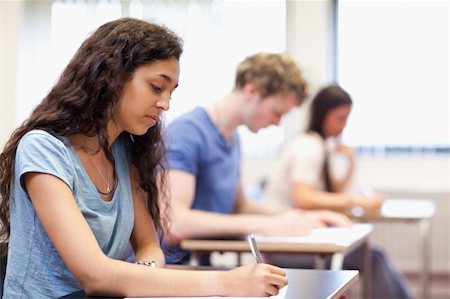 simsearch:400-05677768,k - Studious young adults working on an essay in a classroom Stock Photo - Budget Royalty-Free & Subscription, Code: 400-05677792