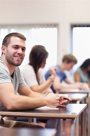 simsearch:400-05677768,k - Portrait of a smiling young man in a classroom Stock Photo - Budget Royalty-Free & Subscription, Code: 400-05677806