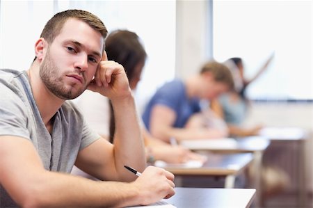 simsearch:400-05677768,k - Young man posing in a classroom Stock Photo - Budget Royalty-Free & Subscription, Code: 400-05677808