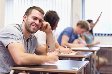 simsearch:400-05677768,k - Smiling young man posing in a classroom Stock Photo - Budget Royalty-Free & Subscription, Code: 400-05677809