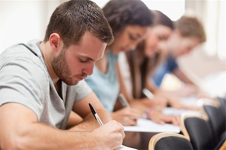 simsearch:400-05677768,k - Serious students sitting for an examination in an amphitheater Stock Photo - Budget Royalty-Free & Subscription, Code: 400-05677829