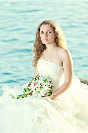 simsearch:400-05328142,k - Beautiful bride sitting on a rock in a sea Stock Photo - Budget Royalty-Free & Subscription, Code: 400-05677890