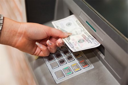 simsearch:400-05670021,k - Feminine hand withdrawing dollars at an ATM Stock Photo - Budget Royalty-Free & Subscription, Code: 400-05670029