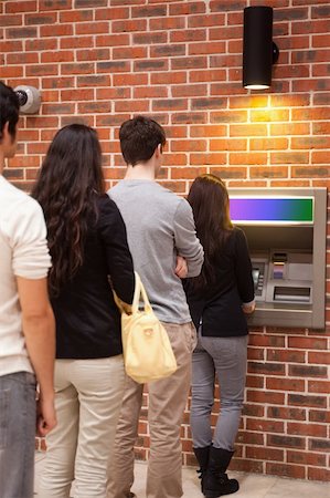 simsearch:400-05670021,k - Portrait of people queuing to withdraw cash at an ATM Stock Photo - Budget Royalty-Free & Subscription, Code: 400-05670020