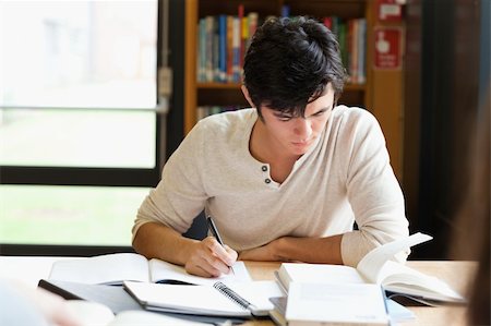 simsearch:400-05669803,k - Male student working on an essay in a library Stock Photo - Budget Royalty-Free & Subscription, Code: 400-05670035