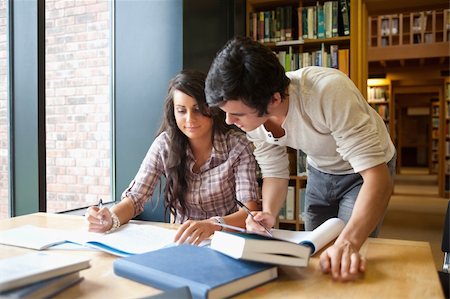 simsearch:400-05669803,k - Two students working together in a library Stock Photo - Budget Royalty-Free & Subscription, Code: 400-05670281
