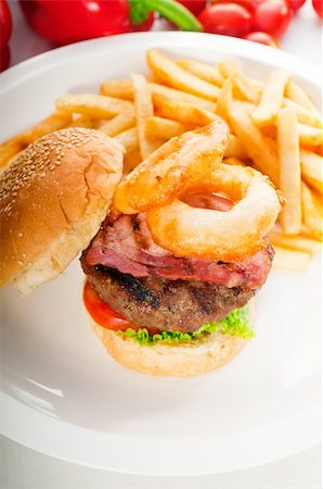 simsearch:400-06090558,k - classic american hamburger sandwich with onion rings and french fries,with fresh vegetables on background, MORE DELICIOUS FOOD ON PORTFOLIO Stock Photo - Budget Royalty-Free & Subscription, Code: 400-05670306