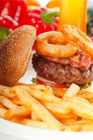 simsearch:400-06090558,k - classic american hamburger sandwich with onion rings and french fries,glass of  beer and fresh vegetables on background,  MORE DELICIOUS FOOD ON PORTFOLIO Stock Photo - Budget Royalty-Free & Subscription, Code: 400-05670309