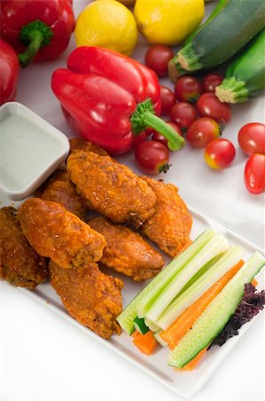 food and fast food - classic  buffalo chicken wings served with fresh pinzimonio and vegetables on background,MORE DELICIOUS FOOD ON PORTFOLIO Photographie de stock - Aubaine LD & Abonnement, Code: 400-05670324