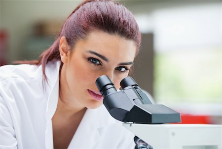 simsearch:400-05669968,k - Close up of a young scientist posing with a microscope in a laboratory Stock Photo - Budget Royalty-Free & Subscription, Code: 400-05670345