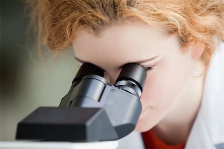 simsearch:400-05669968,k - Close up of a young student looking into a microscope in a laboratory Stock Photo - Budget Royalty-Free & Subscription, Code: 400-05670434