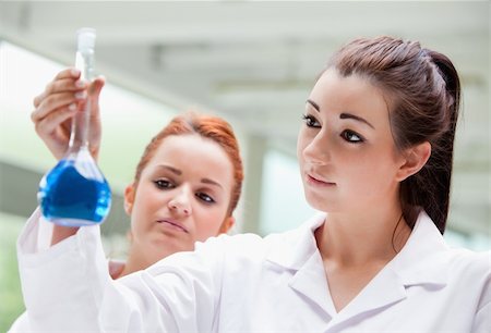 Lab partners looking at a flask in a laboratory Stock Photo - Budget Royalty-Free & Subscription, Code: 400-05670612