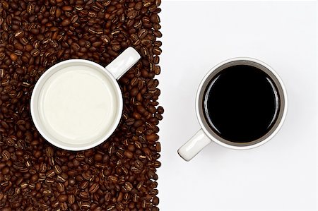 simsearch:400-04744928,k - A cup of black coffee on white background and a cup of white milk on a layer of coffee beans Stock Photo - Budget Royalty-Free & Subscription, Code: 400-05671156