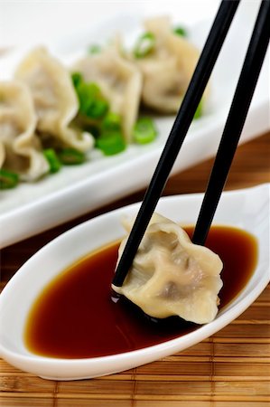 dim sum restaurant photography - Dumpling being dipped in soy sauce with chopsticks Stock Photo - Budget Royalty-Free & Subscription, Code: 400-05671203