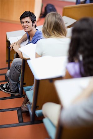 Portrait of a handsome student being distracted in an amphitheater Stock Photo - Budget Royalty-Free & Subscription, Code: 400-05684380