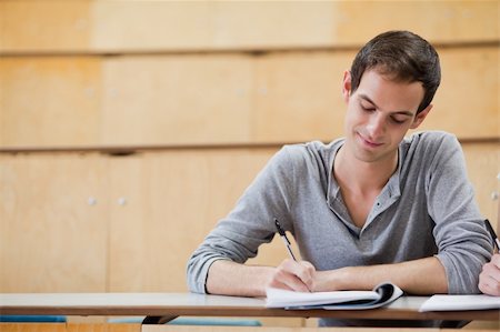 simsearch:400-05677768,k - Portrait of a male student writing on a notepad in an amphitheater Stock Photo - Budget Royalty-Free & Subscription, Code: 400-05684397
