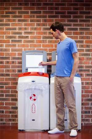 simsearch:400-07301131,k - Portrait of a young man recycling a plastic bottle Stock Photo - Budget Royalty-Free & Subscription, Code: 400-05684446