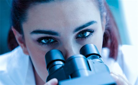simsearch:400-05669968,k - Young scientist looking through a microscope in a laboratory Stock Photo - Budget Royalty-Free & Subscription, Code: 400-05684514