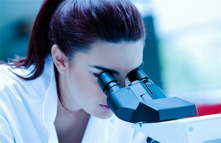 simsearch:400-05669968,k - Young scientist using a microscope in a laboratory Stock Photo - Budget Royalty-Free & Subscription, Code: 400-05684511