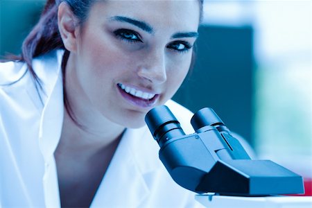 simsearch:400-05669968,k - Young scientist posing with a microscope in a laboratory Stock Photo - Budget Royalty-Free & Subscription, Code: 400-05684512