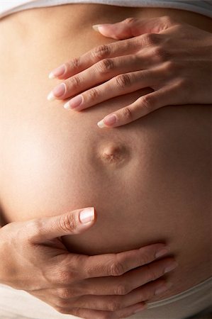 pregnancy nude - Detail Of Pregnant Woman Holding Stomach Stock Photo - Budget Royalty-Free & Subscription, Code: 400-05686485