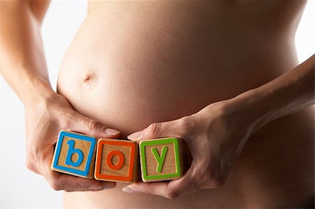 pregnancy nude - Pregnant Woman Holding Blocks Spelling "Boy" Stock Photo - Budget Royalty-Free & Subscription, Code: 400-05686494
