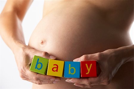 pregnancy nude - Pregnant Woman Holding Blocks Spelling "Baby" Stock Photo - Budget Royalty-Free & Subscription, Code: 400-05686492