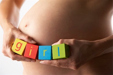 pregnancy nude - Pregnant Woman Holding Blocks Spelling "Girl" Stock Photo - Budget Royalty-Free & Subscription, Code: 400-05686493