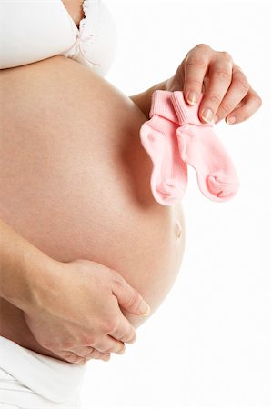 pregnancy nude - Pregnant Woman Holding Pink Baby Socks Photographie de stock - Aubaine LD & Abonnement, Code: 400-05686518