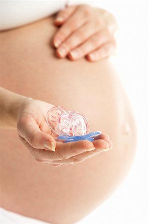 pregnancy nude - Pregnant Woman Holding Pink And Blue Baby Dummies Photographie de stock - Aubaine LD & Abonnement, Code: 400-05686519