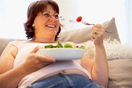 Overweight Woman Relaxing On Sofa Stock Photo - Budget Royalty-Free & Subscription, Code: 400-05686623