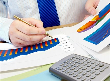 simsearch:400-04005642,k - Businessman analyzing investment charts at his workplace. Stock Photo - Budget Royalty-Free & Subscription, Code: 400-05687641