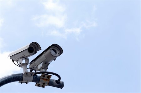 CCTV cameras on high towers in the background sky. Stock Photo - Budget Royalty-Free & Subscription, Code: 400-05682409