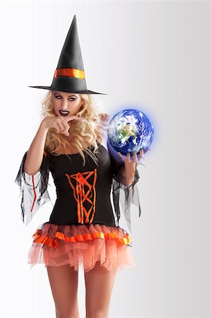 simsearch:400-05693792,k - close up of a very sensual cute blond witch in orange and black dress with large hat making magig with a world ball Stock Photo - Budget Royalty-Free & Subscription, Code: 400-05694372