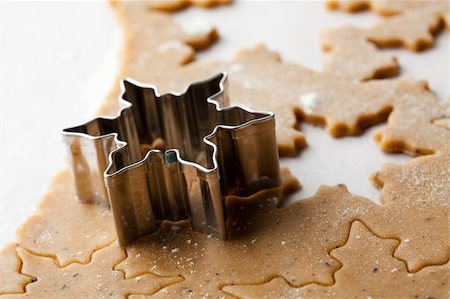 simsearch:400-05721521,k - Making gingerbread cookies for Christmas. Gingerbread dough with star shapes and a cutter. Stock Photo - Budget Royalty-Free & Subscription, Code: 400-05696396