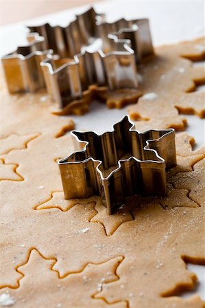 simsearch:400-05721521,k - Making gingerbread cookies for Christmas. Gingerbread dough with star shapes and a cutter. Stock Photo - Budget Royalty-Free & Subscription, Code: 400-05696399