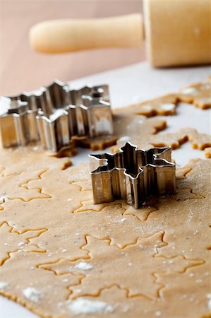 simsearch:400-05721521,k - Making gingerbread cookies for Christmas. Gingerbread dough with star shapes and a cutter. Stock Photo - Budget Royalty-Free & Subscription, Code: 400-05696400
